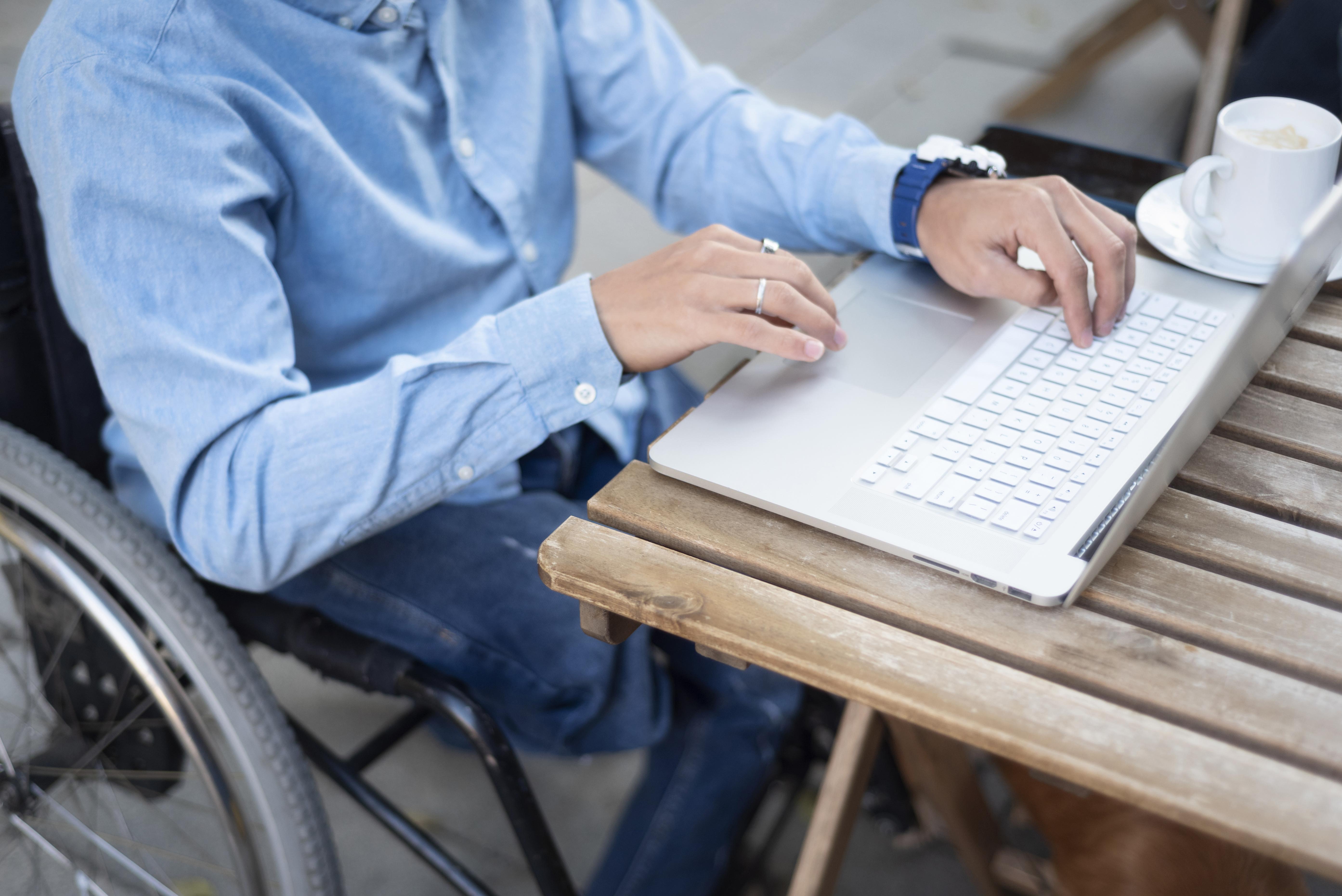 close-up-disabled-man-typing-laptop